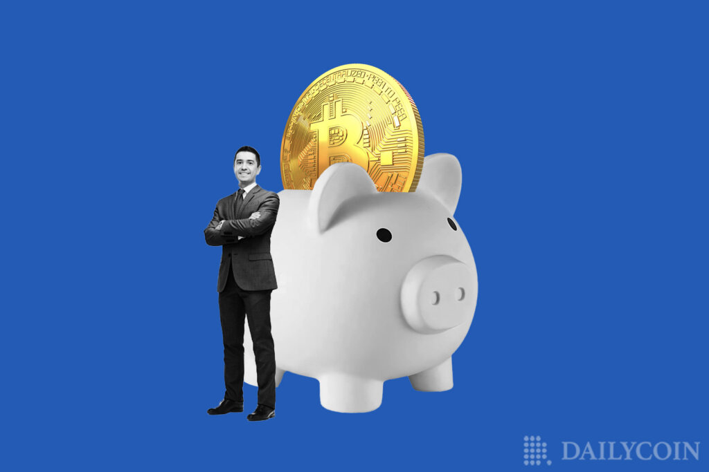 A man standing next to a giant piggy bank with Bitcoin coin.