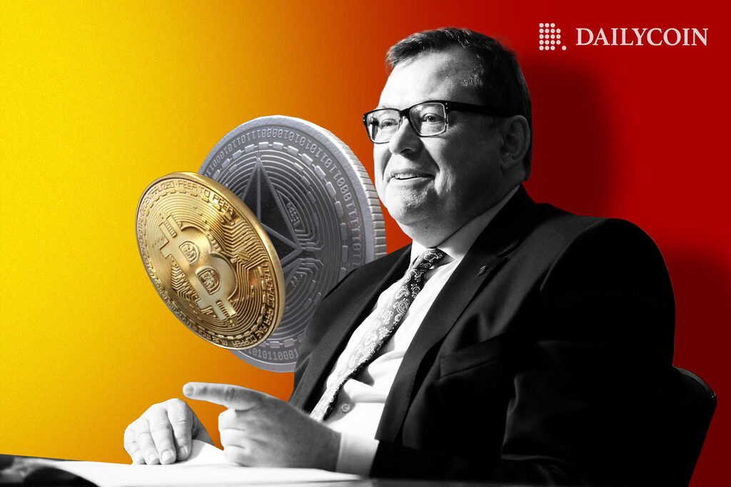 Belgian politician holding up giant Ethereum and Bitcoin coins