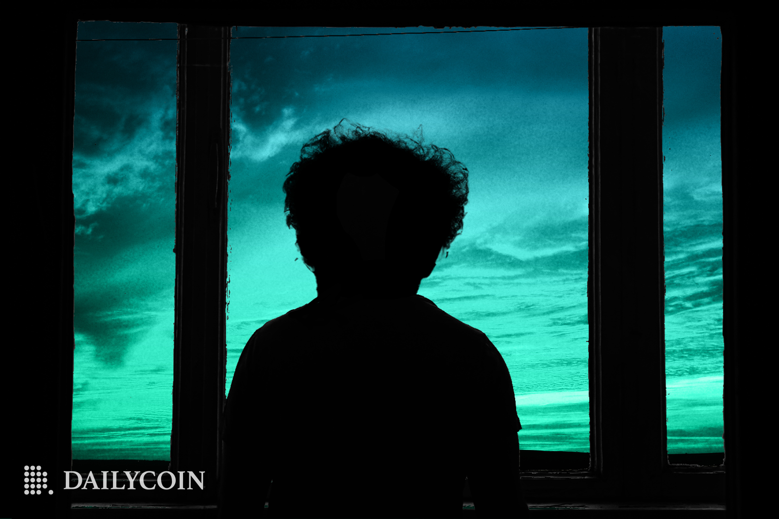 A silhouette of Sam Bankman Fried in front of a window looking at blue sky with clouds