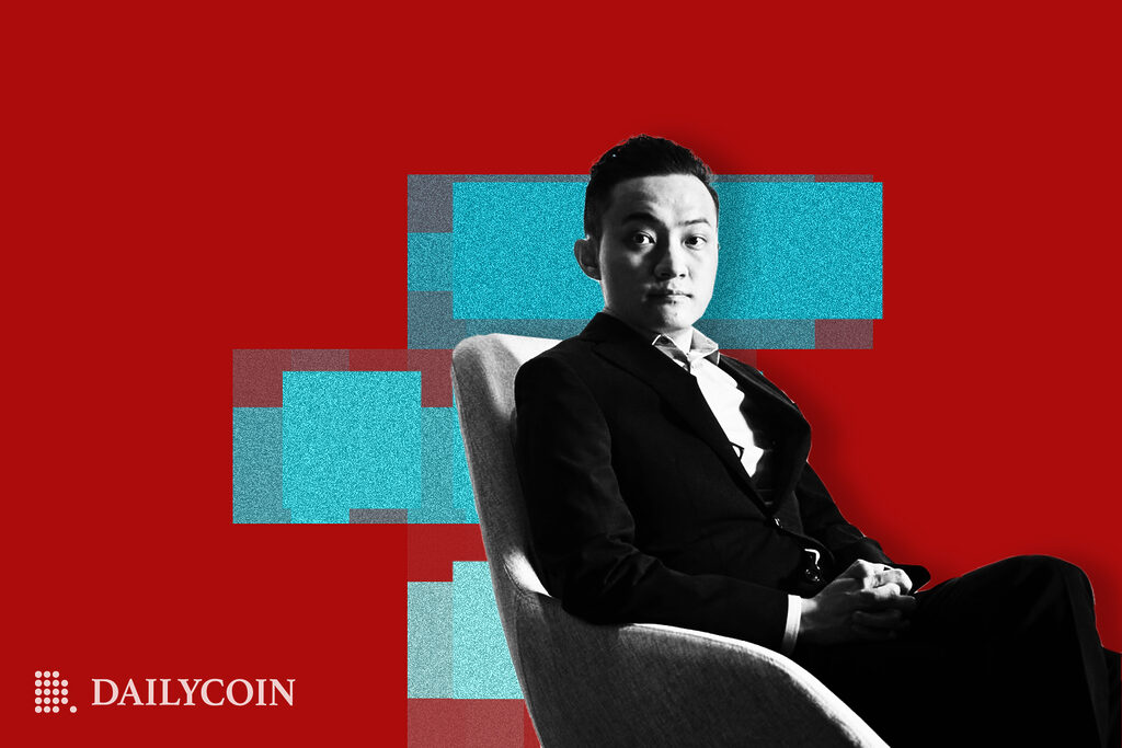 Justin sun sitting in a chair.