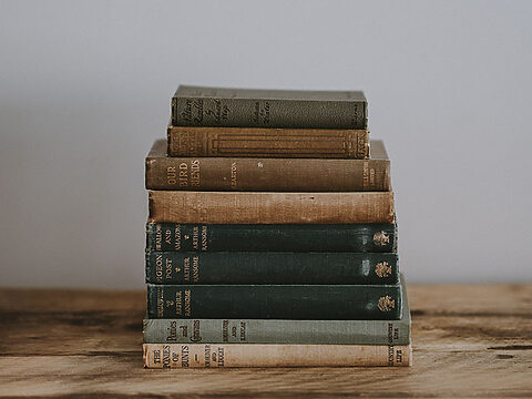 Old books stacked on the table.