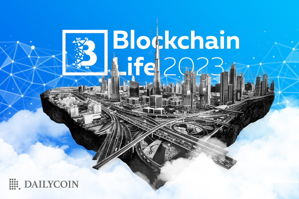 The city of Dubai in clouds, in front of a Blockchain Life 2023 banner.