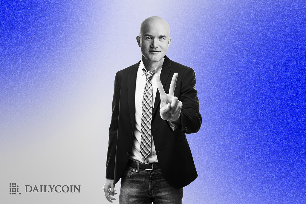 Coinbase CEO Brian Armstrong holding up a peace hand gesture