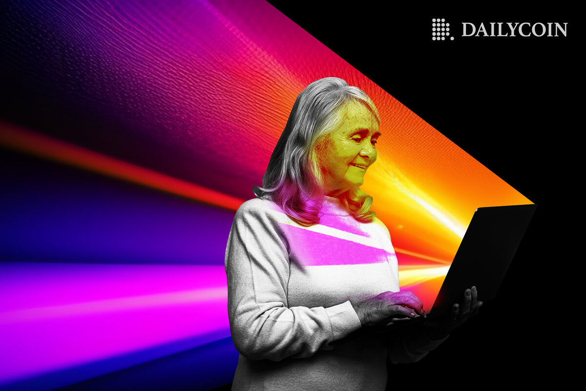 Happy elderly lady using laptop.