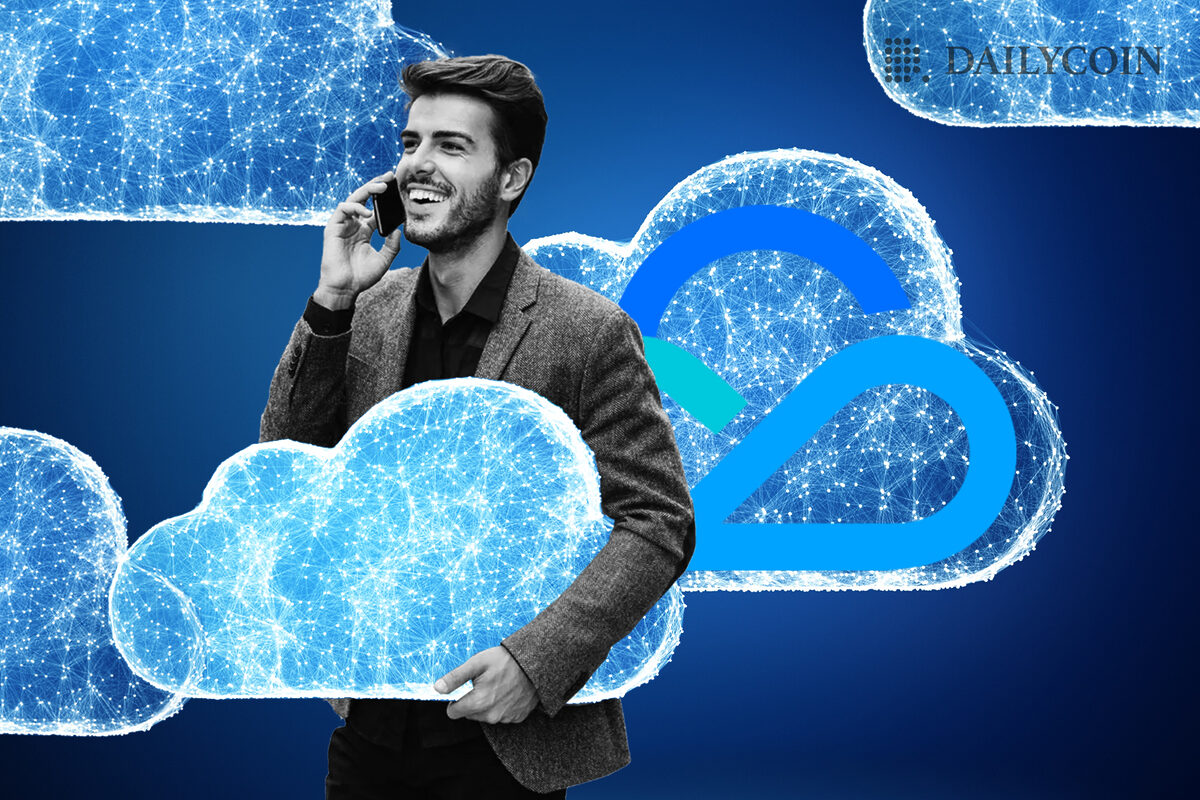 A guy smiling while talking on the phone and holding a cloud