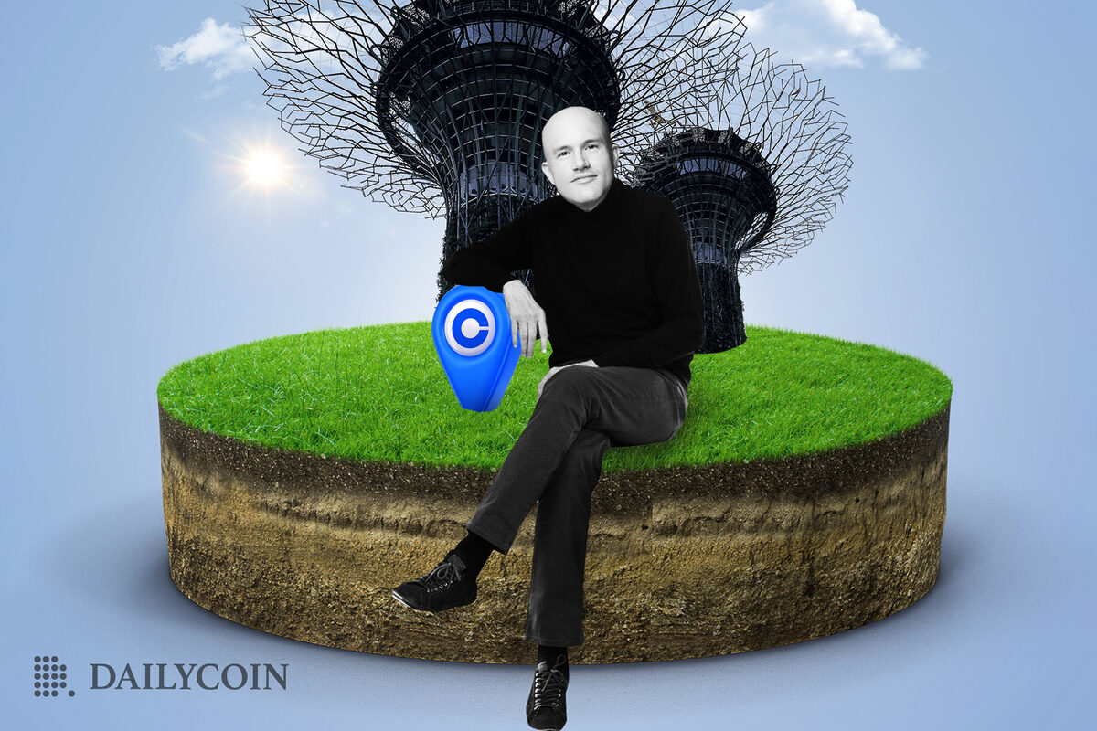 Coinbase CEO standing on some dirt, in front of Singapore's Supertrees