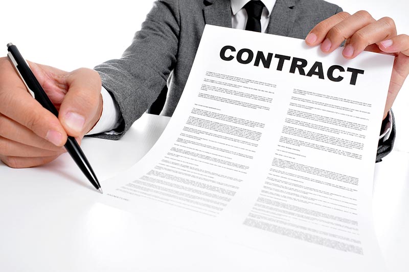 Suited individual presents contract.