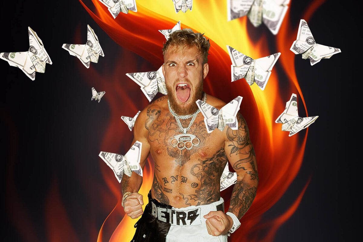 Jake Paul grins as butterflies made out of money fly in a fiery background.