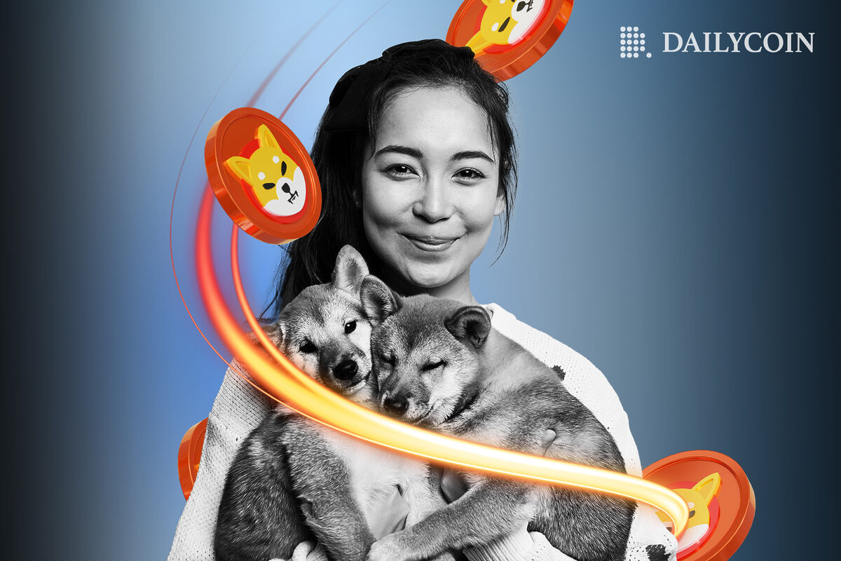 Smiling brunette girl holding two Shiba Inu puppies in her arms is surrounded by SHIB tokens.