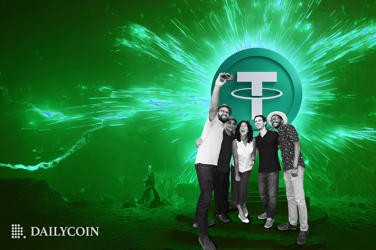A group of people taking a photo in front of a glowing Tether sign.