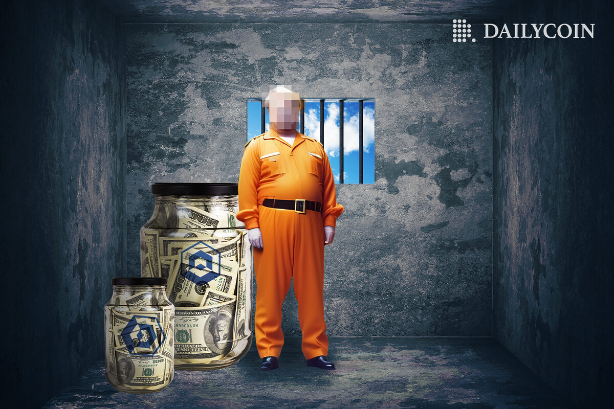 A man in prison clothes stands in a cell next to two jars full of dollars