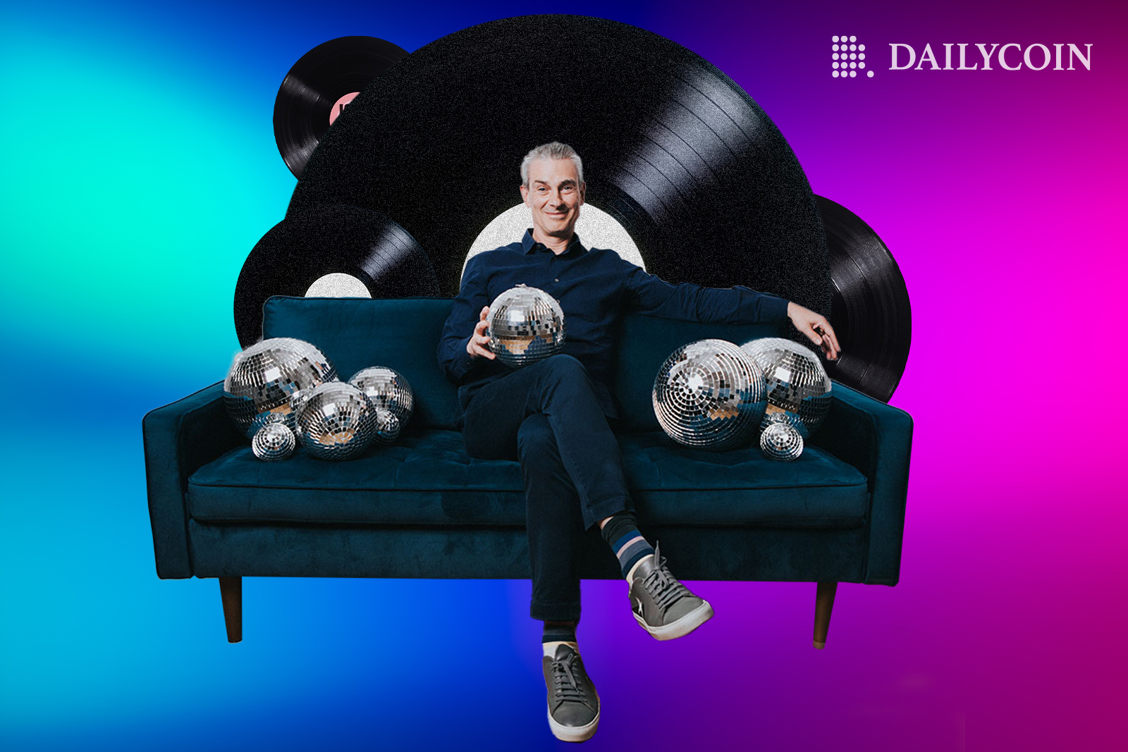 Patrick Moxey sitting on a green sofa and holding disco balls in front of Helix Records.