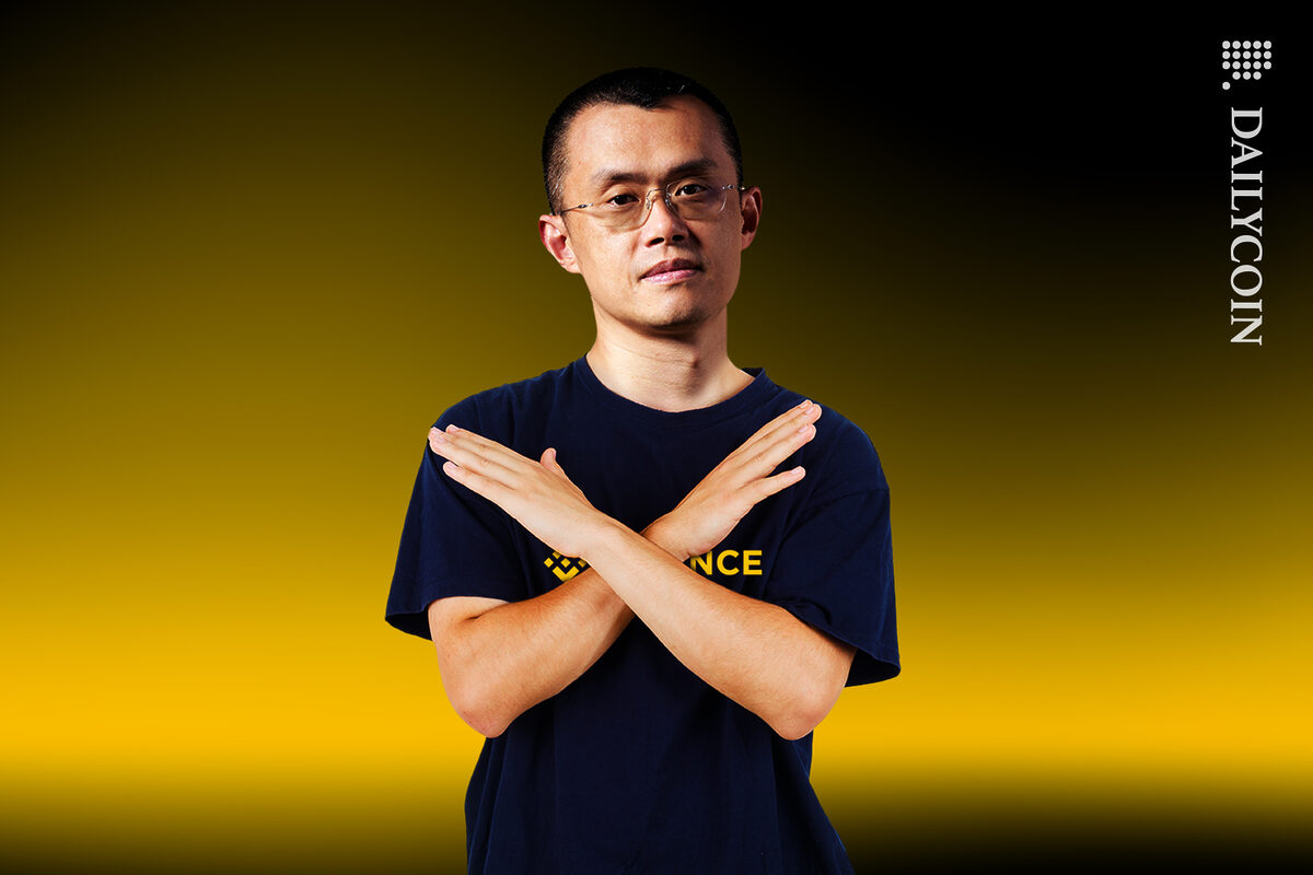 Binance CEO Changpeng Zhao showing x with hands.
