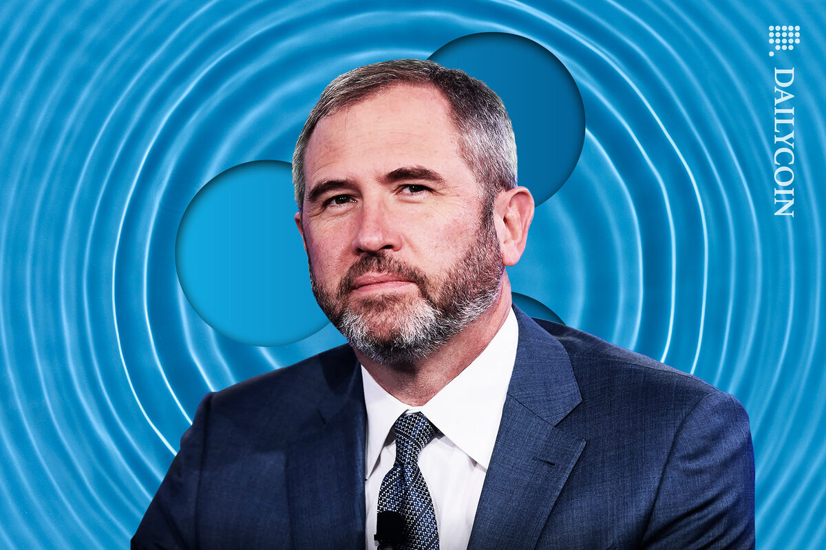 Ripple CEO Brad Garlinghouse with ripple water and Ripple logo behind him.