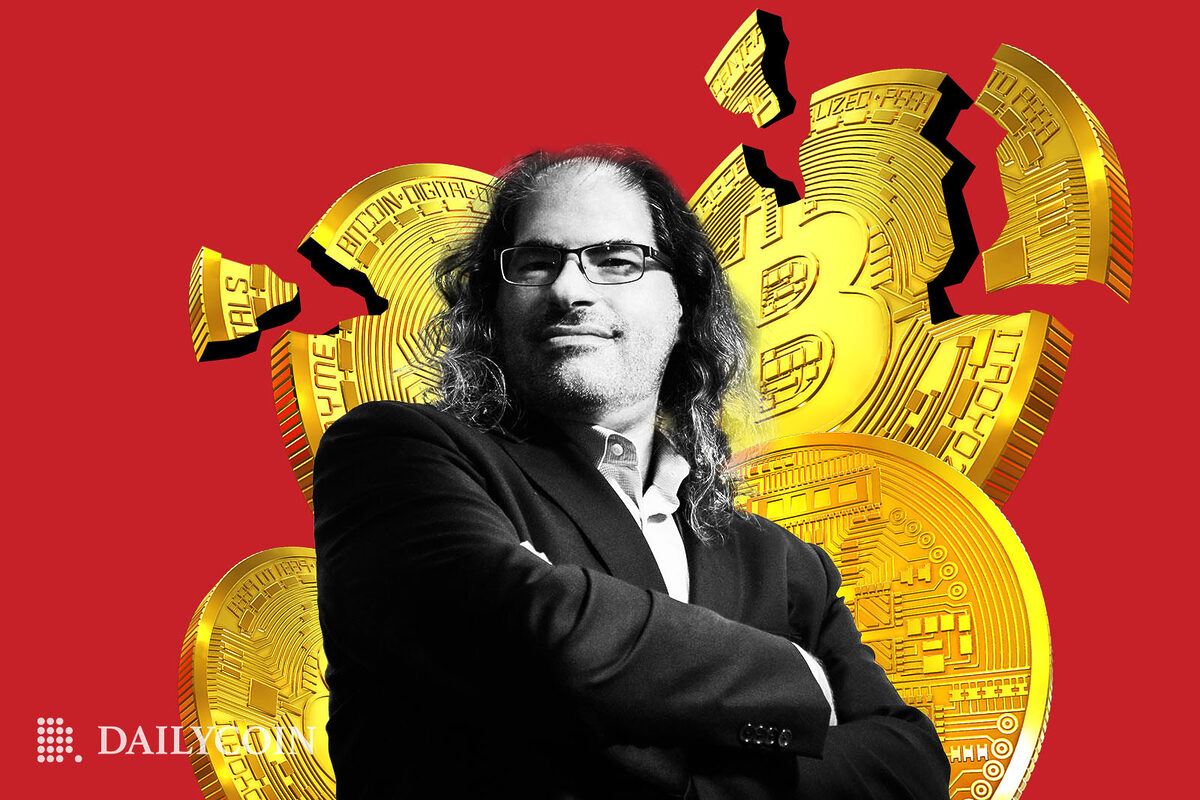 David Schwartz standing in front of shattered Bitcoin.