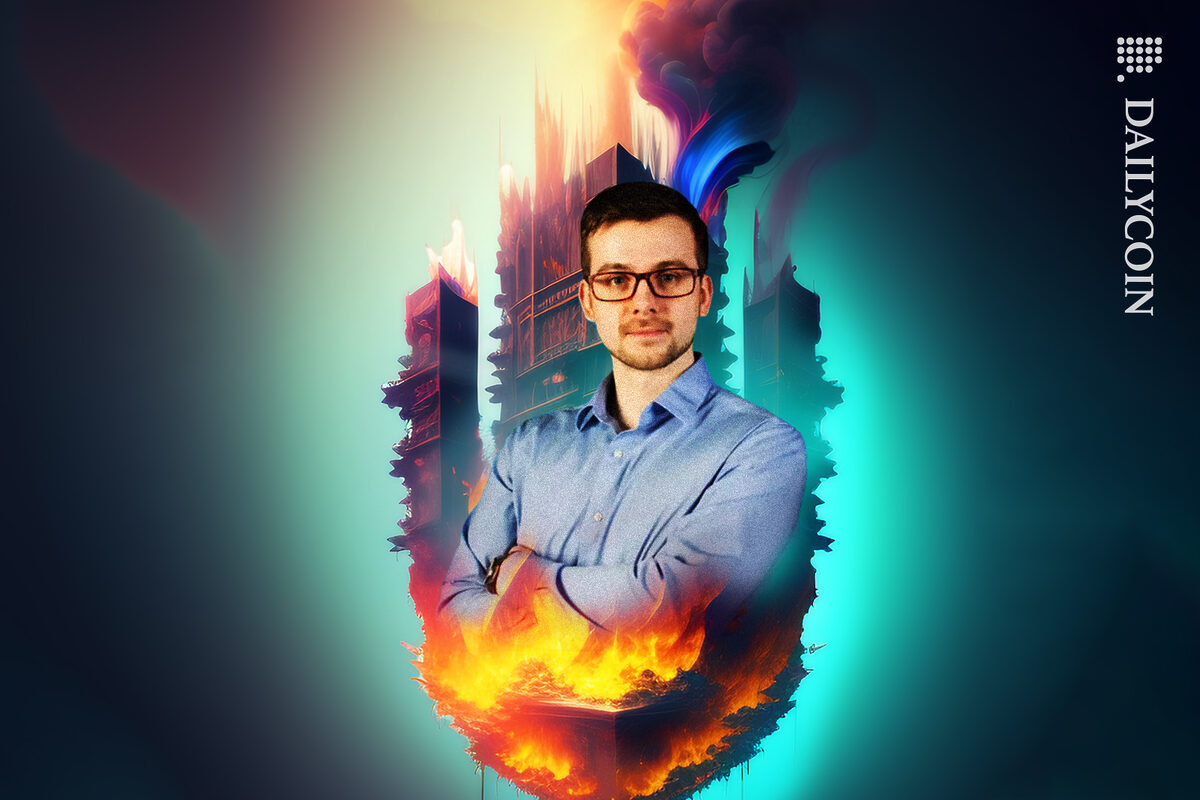Alexey Pertsev portrait with crossed arms in front of a city on fire and smoke behind him.