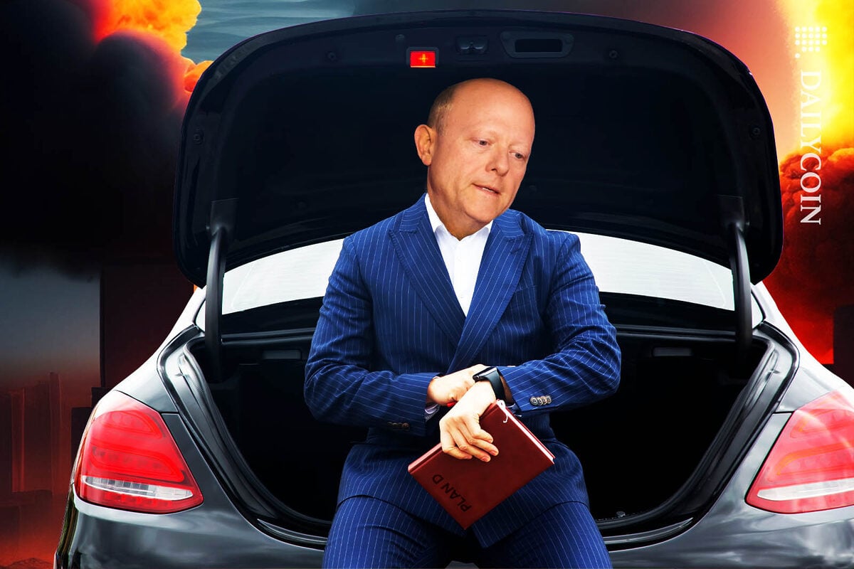 Jeremy Allaire of Circle is looking at his watch whilst sitting on the back of his car, ready to leave.
