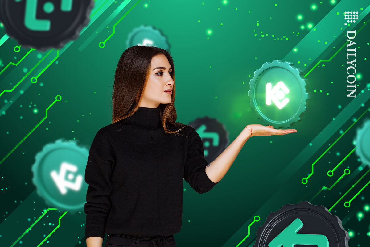 Lady in Kucoin space holding a Kucoin coin.