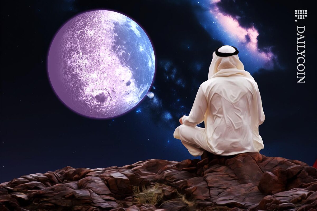 Arab man sitting on a cliff staring at the moon.