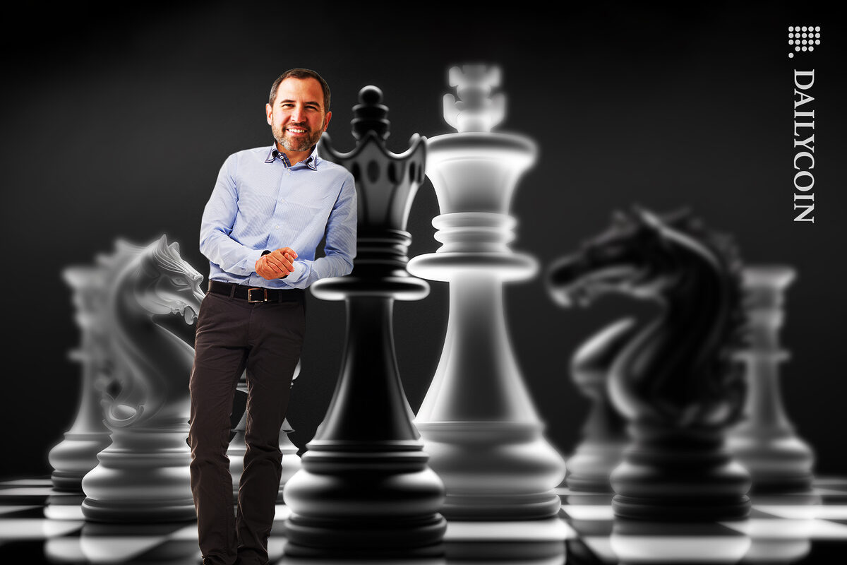 Brad Garlinghouse leaning on a chess peace smilling.