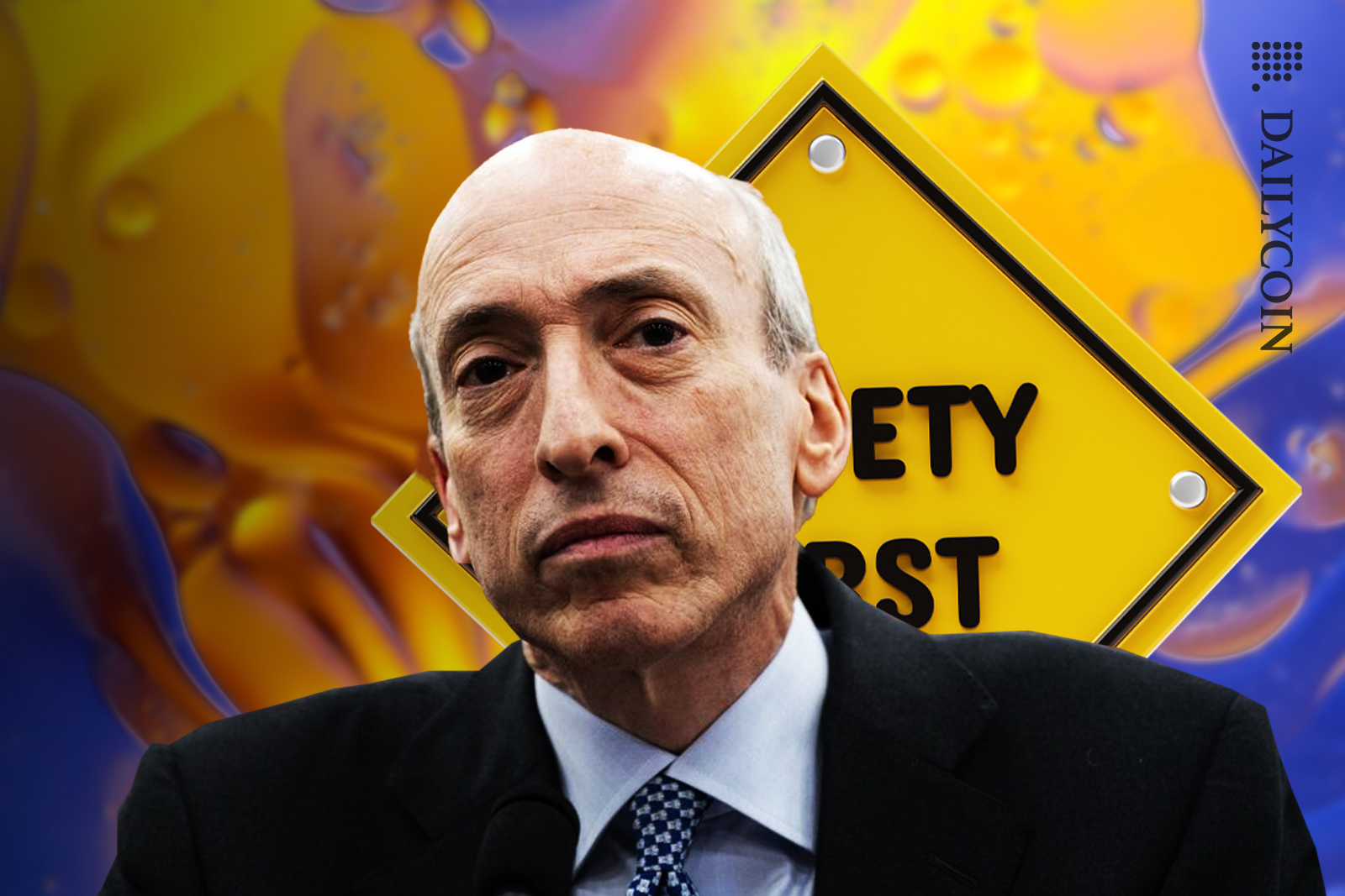 Gary Gensler showing no emotions, ''safety first'' sign behind him.