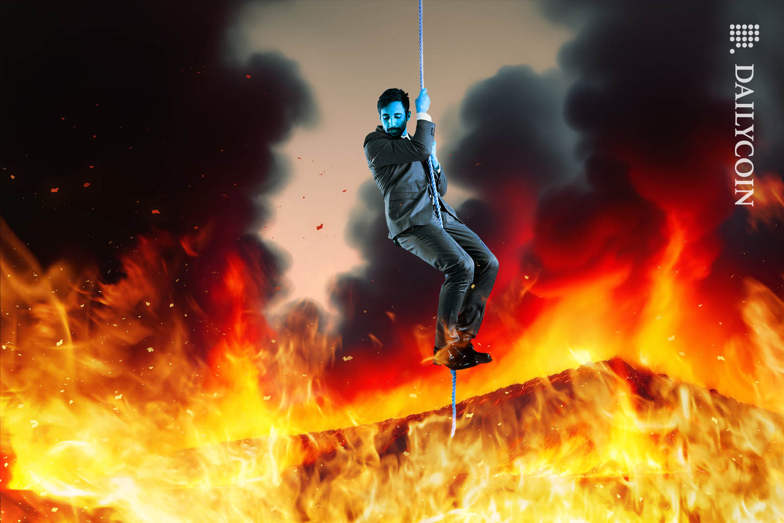 Blue man hanging on a rope above fiery inferno.