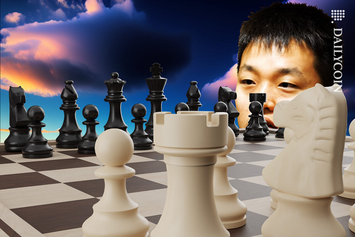 Do kwon contemplating his next move in front of giant chess board.