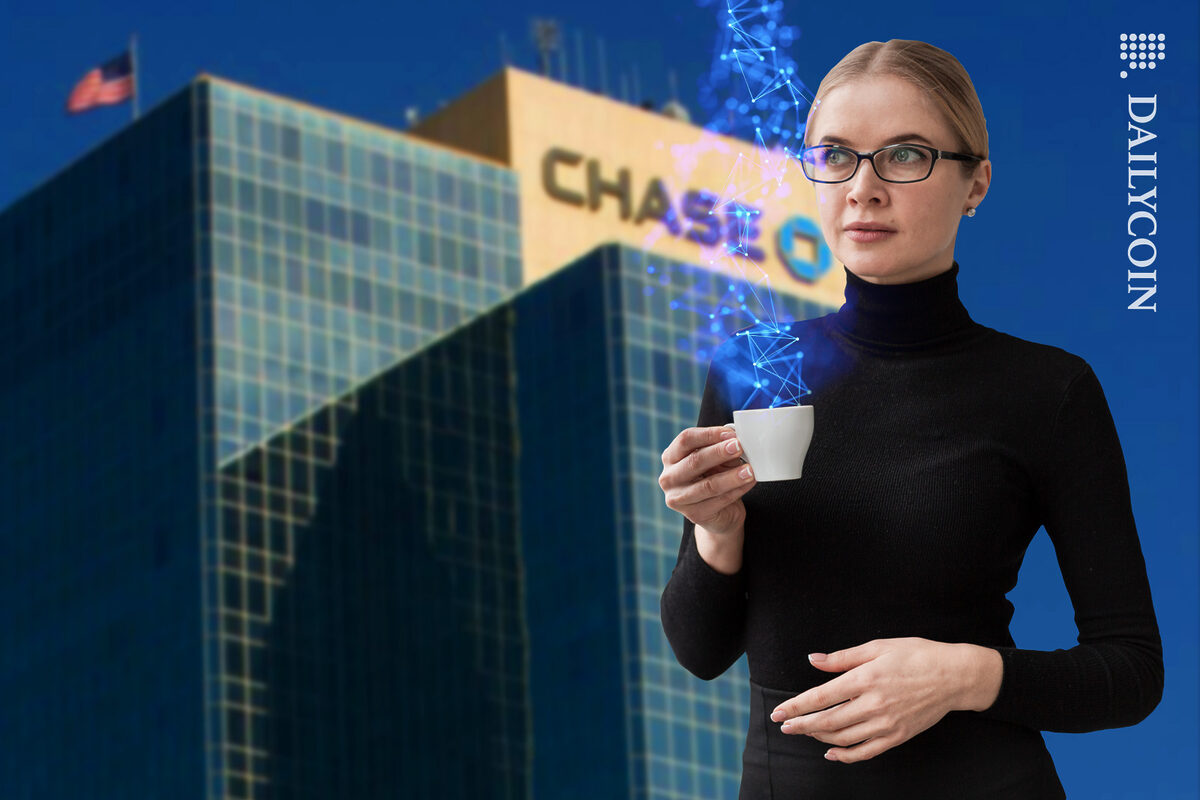 Serious looking woman thinking with a cup of crypto coffee infront of a Chase Bank building.