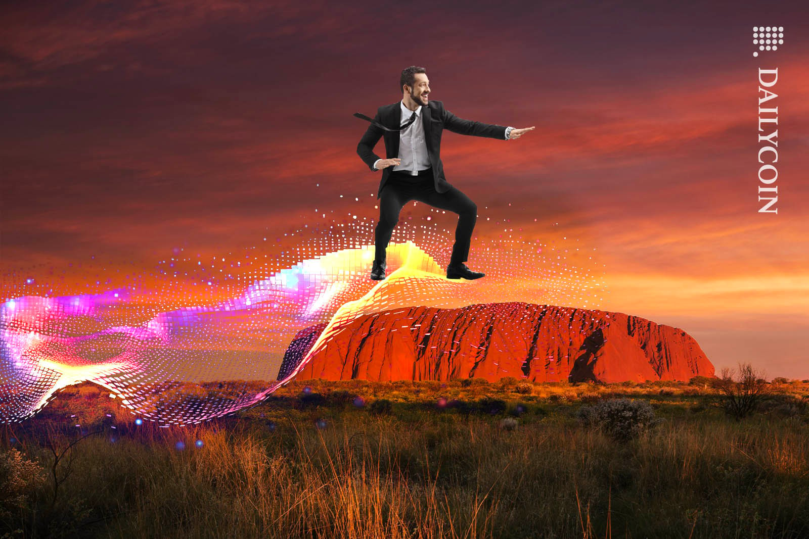 Man in suit surfing a digital wave above the red rock of Uluru.