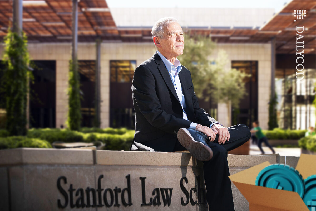 Joseph Bankman sitting outside of Stanford Law School with a box of returned FTX coins.