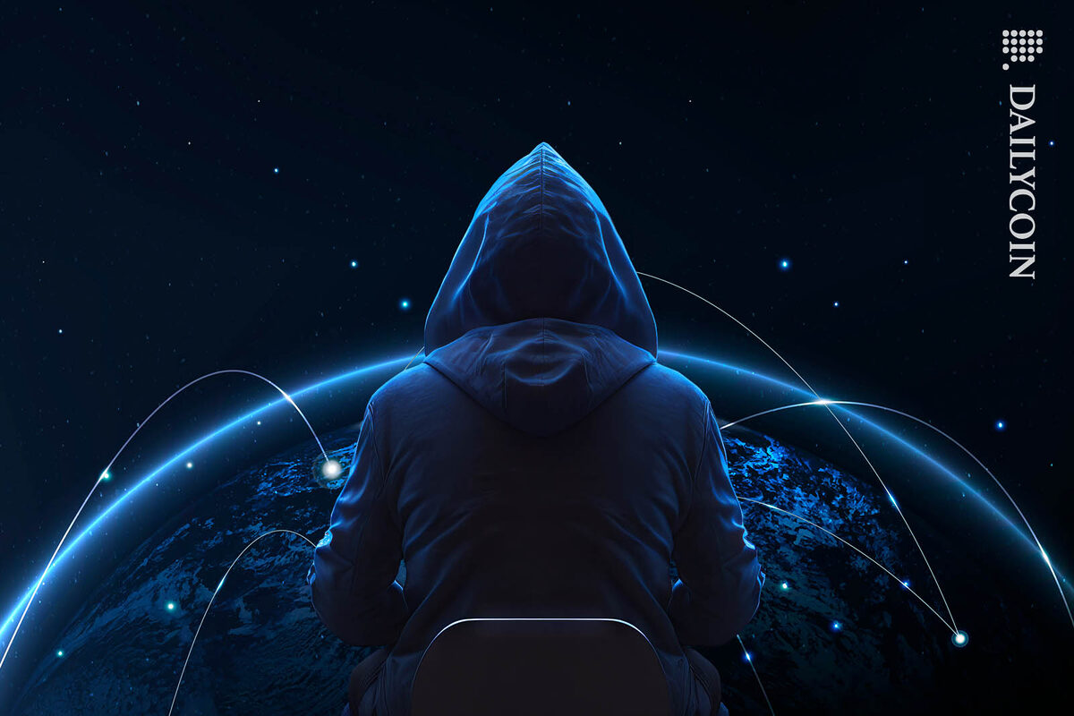 Hacker sitting infront of a digital globe, making transactions.