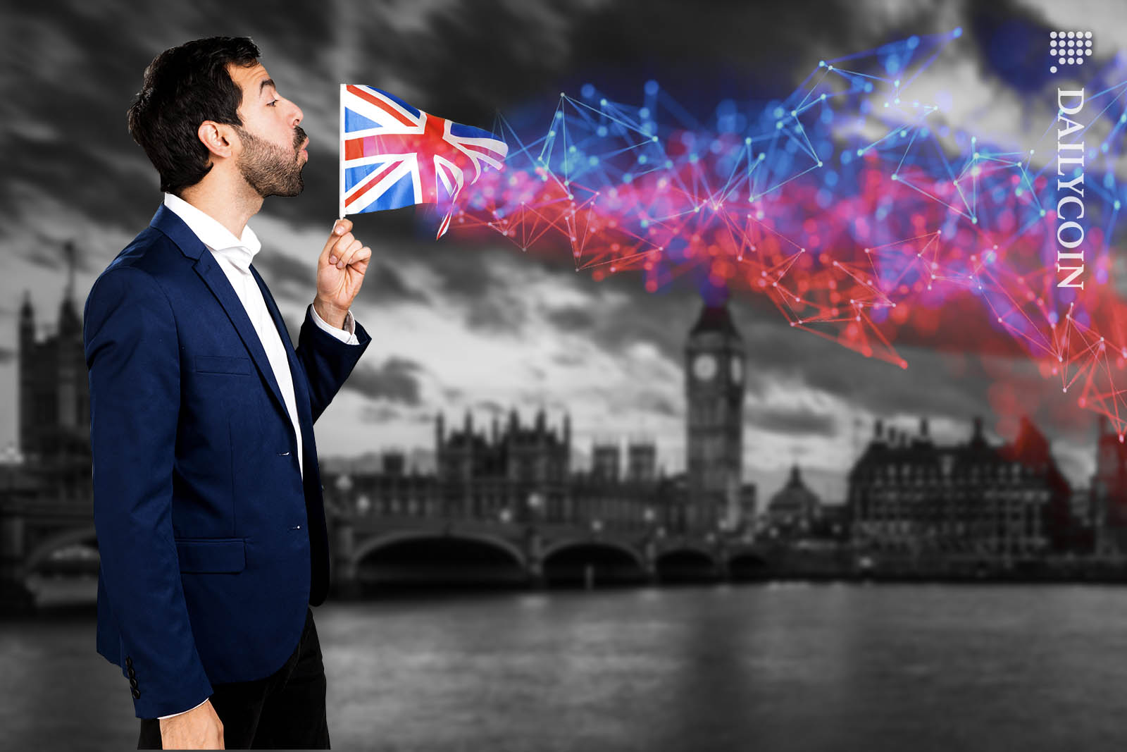 Handsome man blowing a Union Jack flag infront of the London skyline.