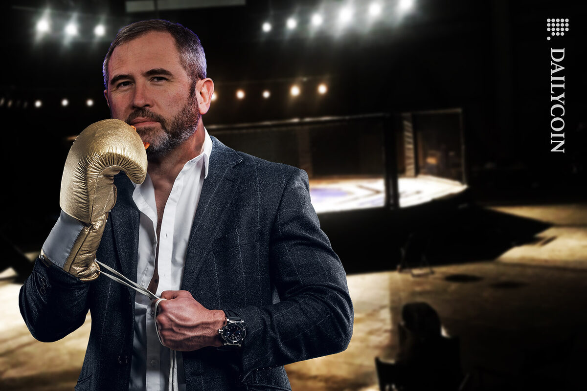 Bred Garlinghouse putting on Golden boxing gloves, ready for a fight.