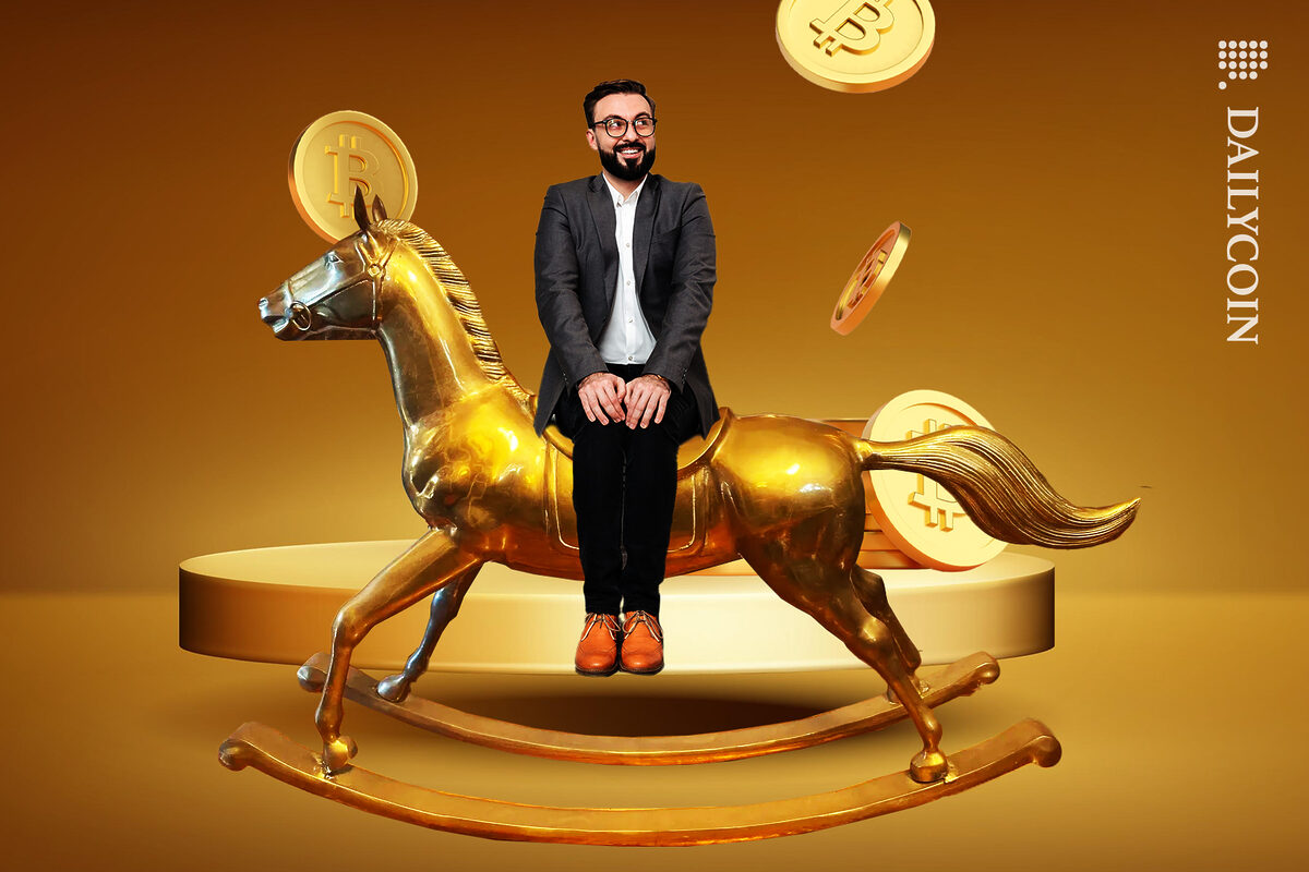 Man happy to have a Custodia Bank bitcoin experience. Riding the rocking horse made of solid gold.