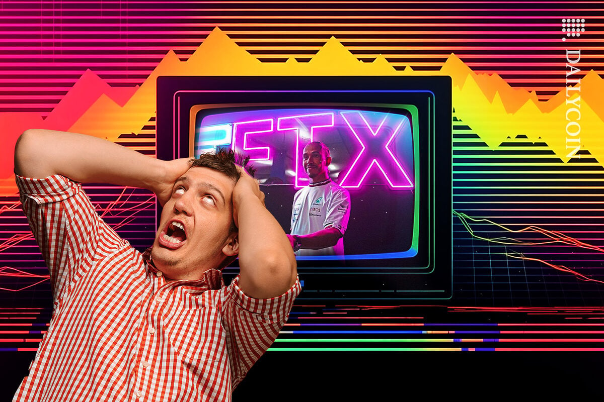 Man being all dramatic next to a TV showing Lewis Hamilton next to a massive FTX neon sign.