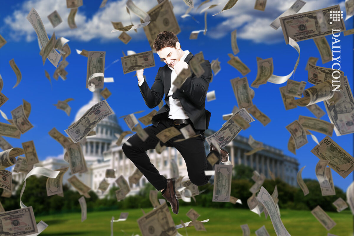 Man in suit jumps with joy surrounded by money faling from the sky infront of the Capitol Building.