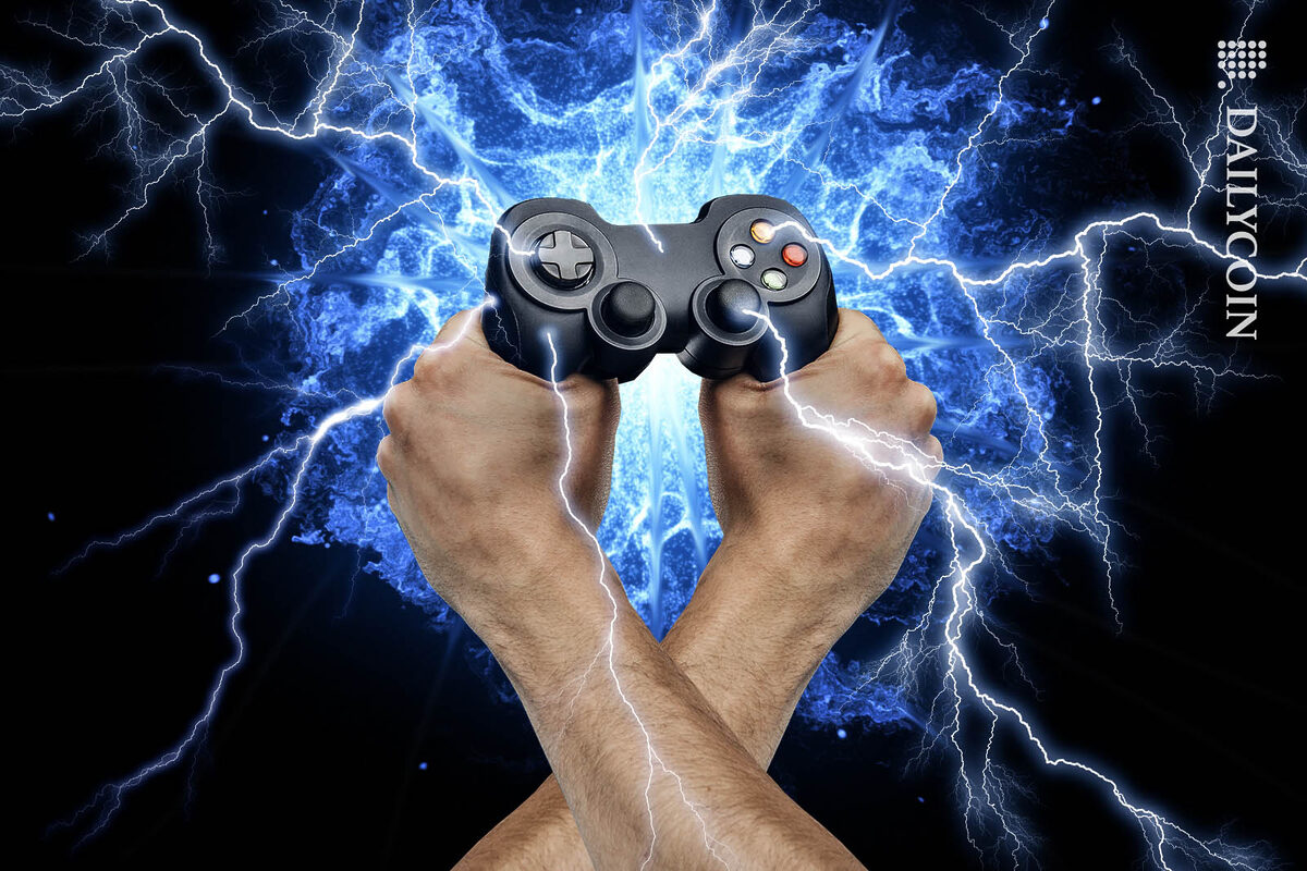 Gaming controller held by two hands emitting energy.