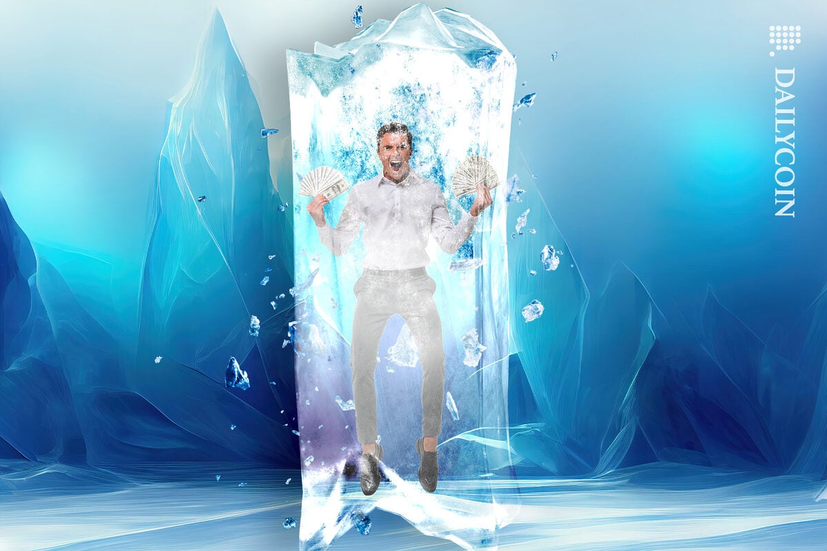 Man angry holding cash frozen in ice
