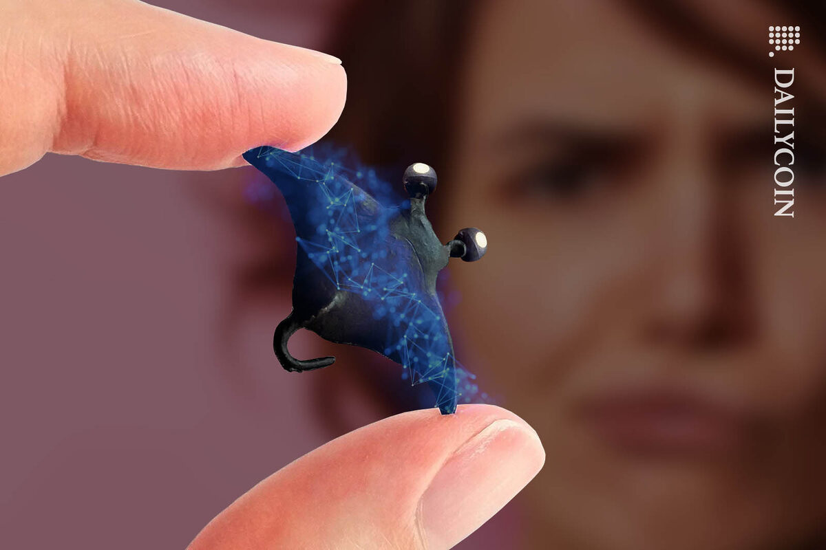 Woman looking disappointed about a very tiny stupid looking manta ray.
