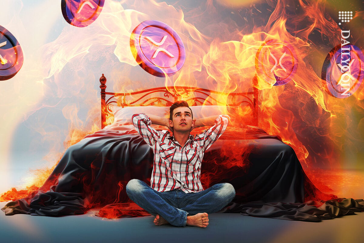 Guy is fearing and imagining what is going to happen to XRP and his world. XRP tokens in flames and his room is filled with fire too.