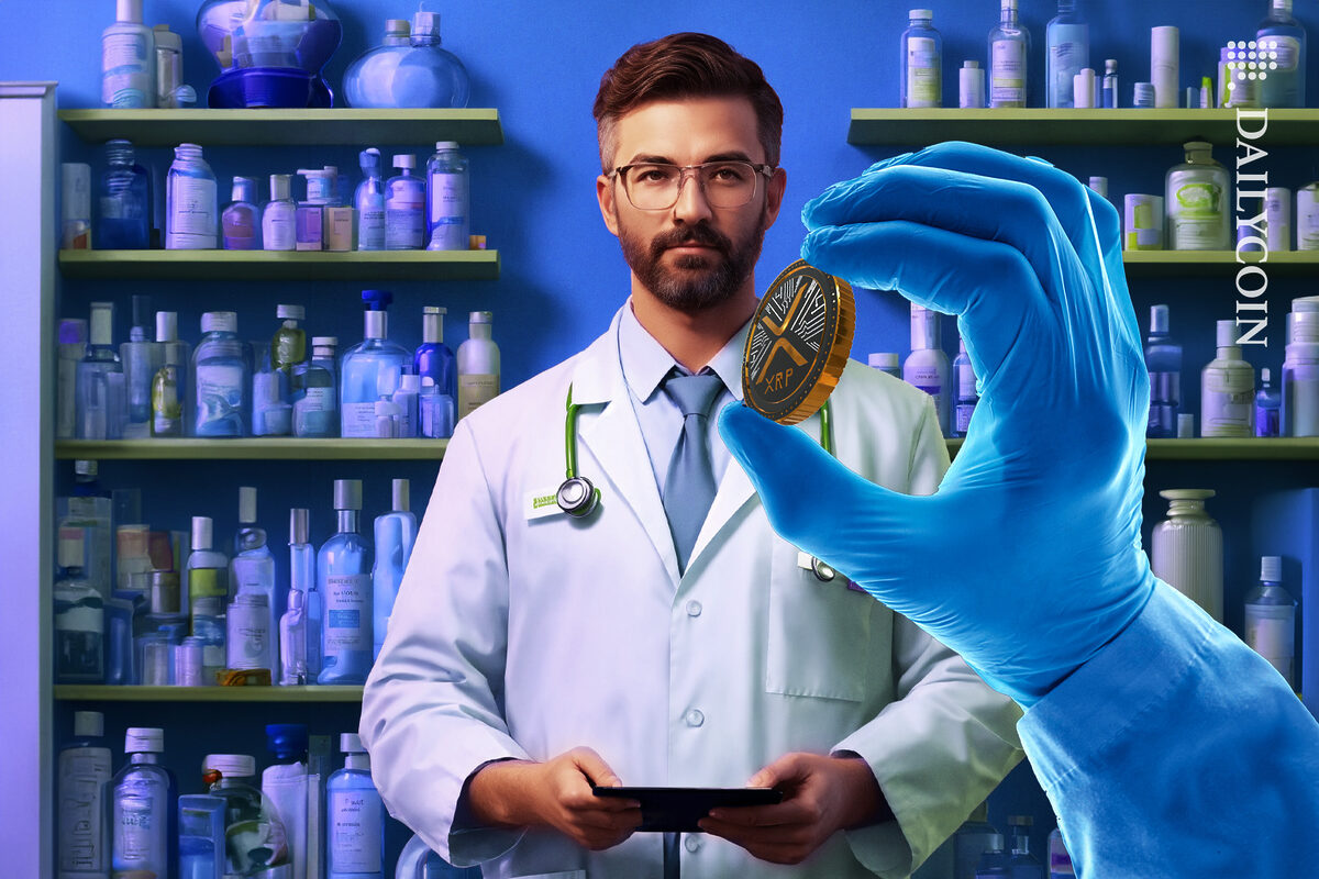 A hand showing xrp coin to a doctor.