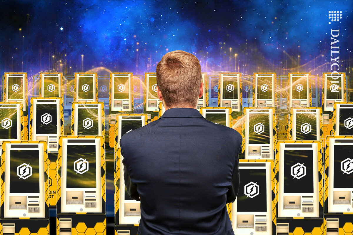 Executive man looking at an army of Bitcoin Depot ATMs.