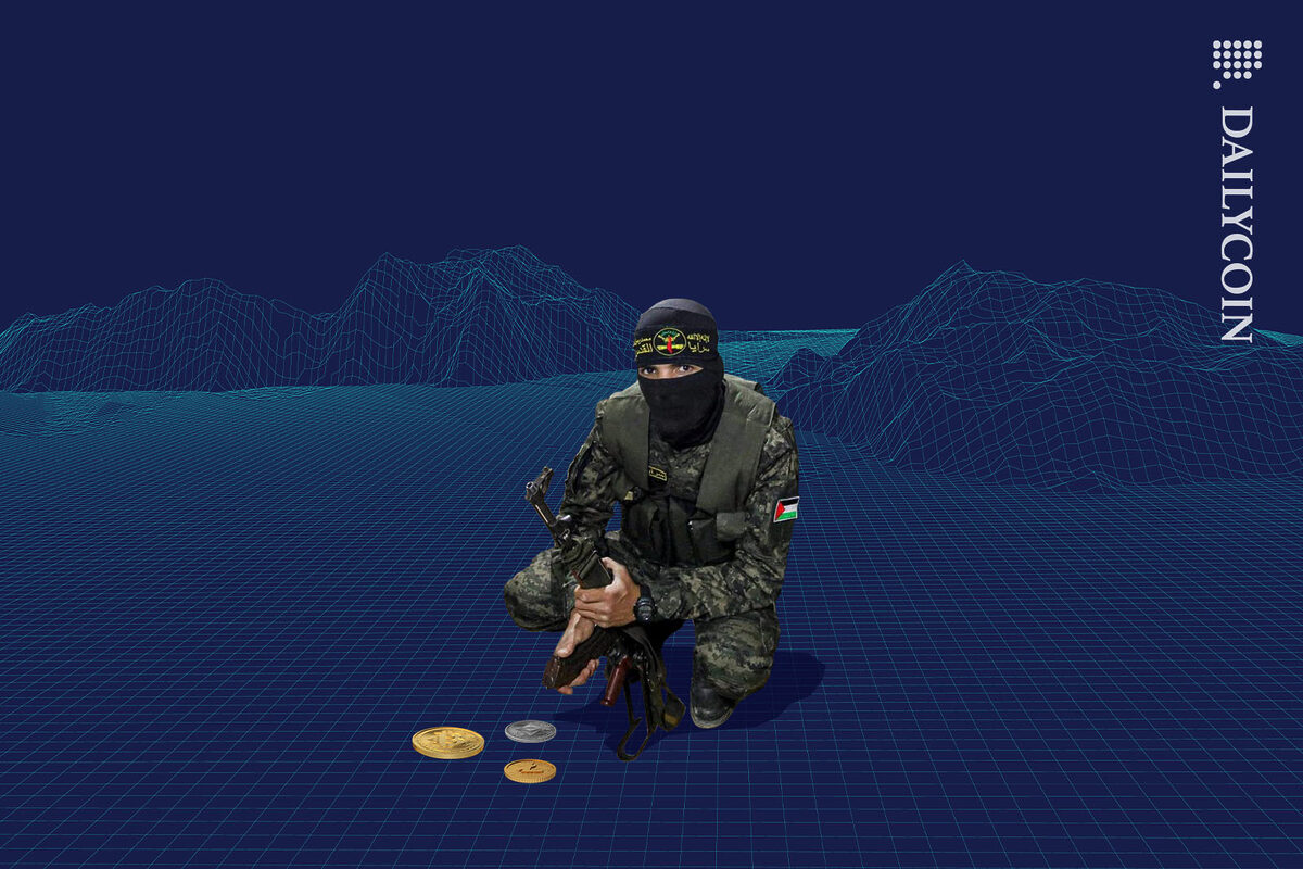 Hamas soldier squatting next to a few small crypto coins.