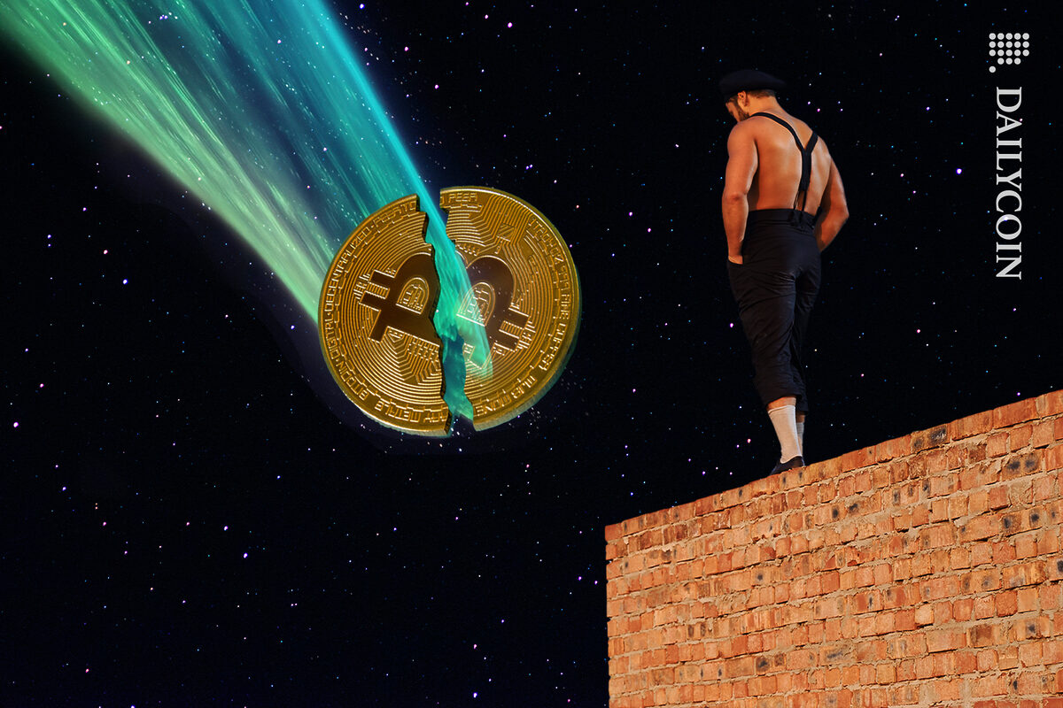 A force from the sky splitting the Bitcoin in half. A man is standing on top of a wall watching it happen in the night sky.