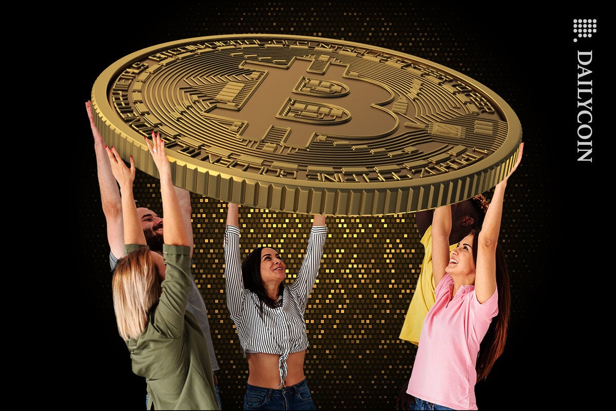 People carrying a huge Bitcoin over their heads.