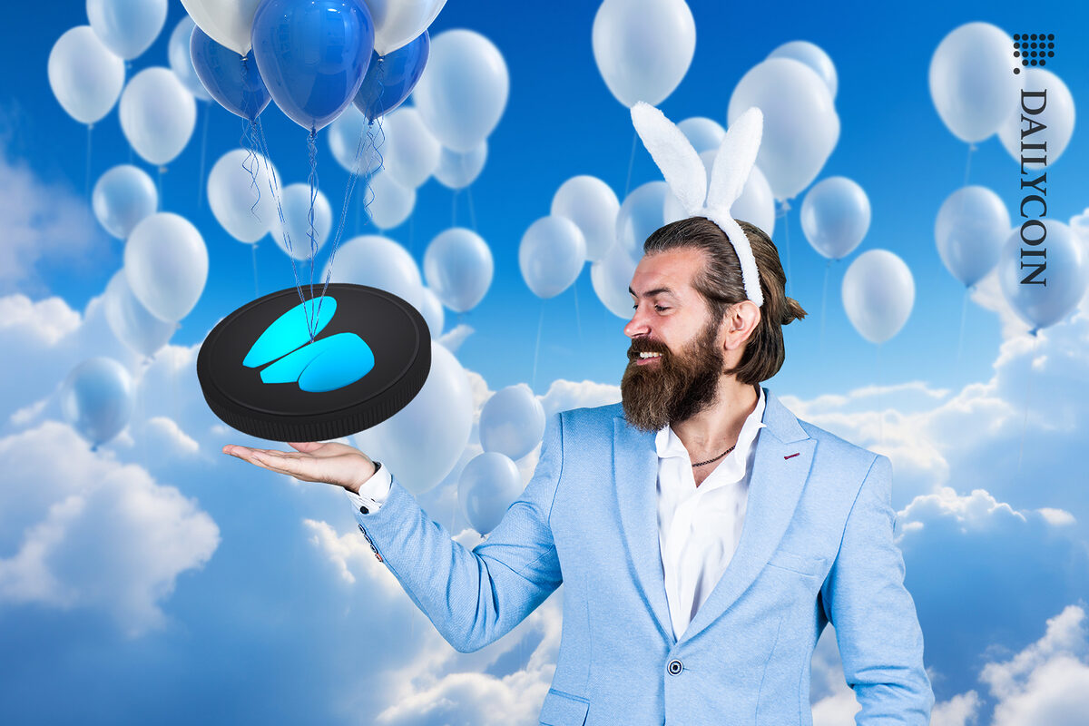 A man with bunny ears, receiving a new Friend.tech coin with balloons.