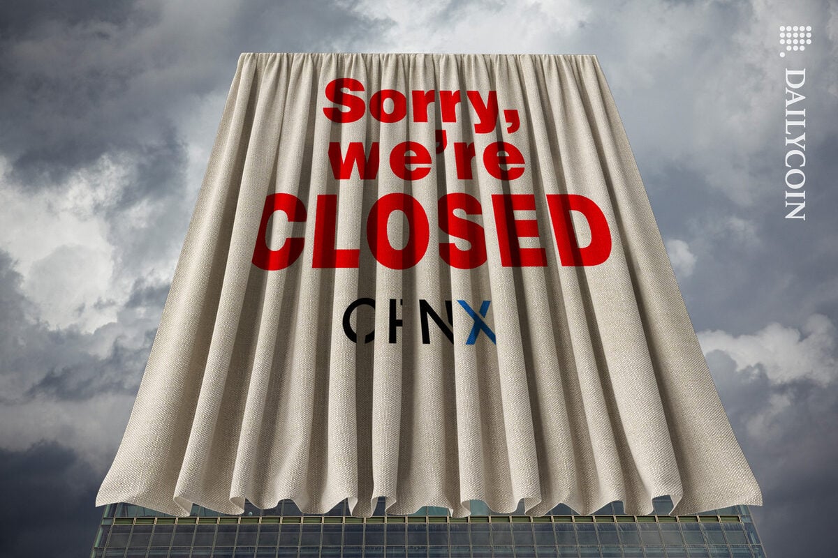OPNX building covered in a cloth with a sign, sorry we're closed.
