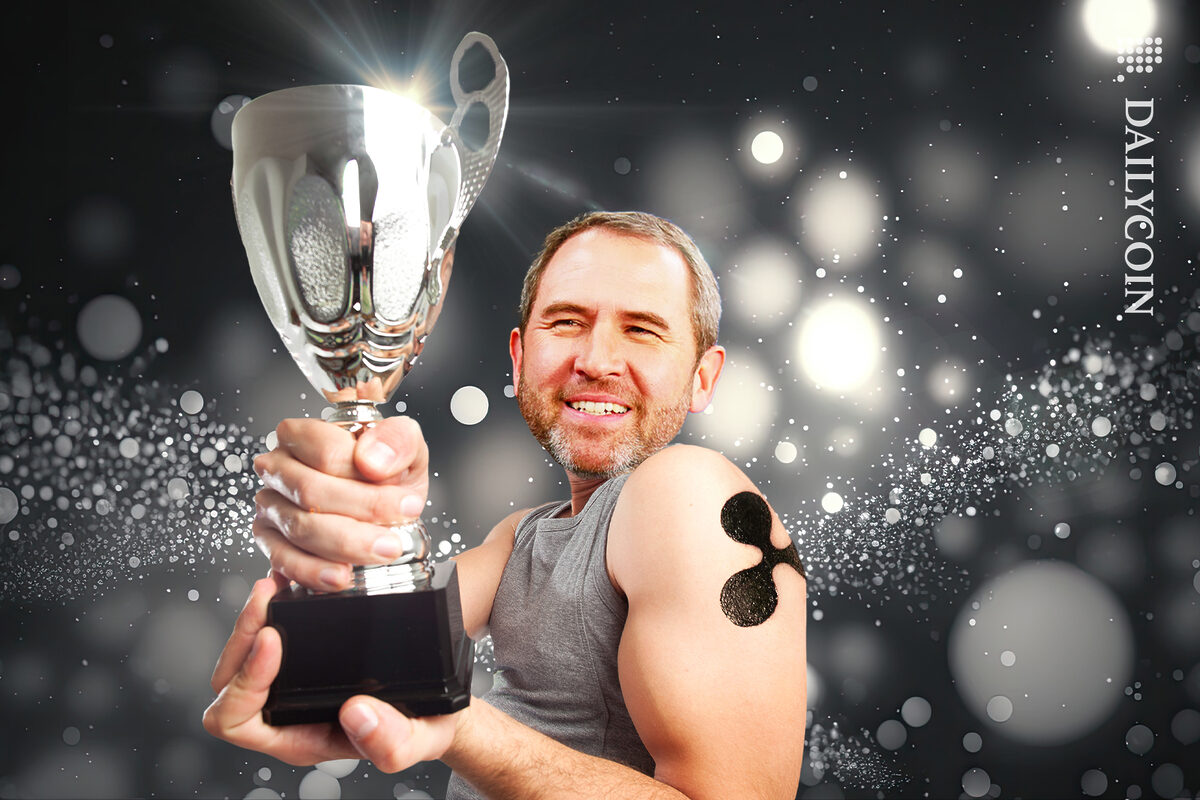 Brad Garlinghouse holding up a silver throphy.