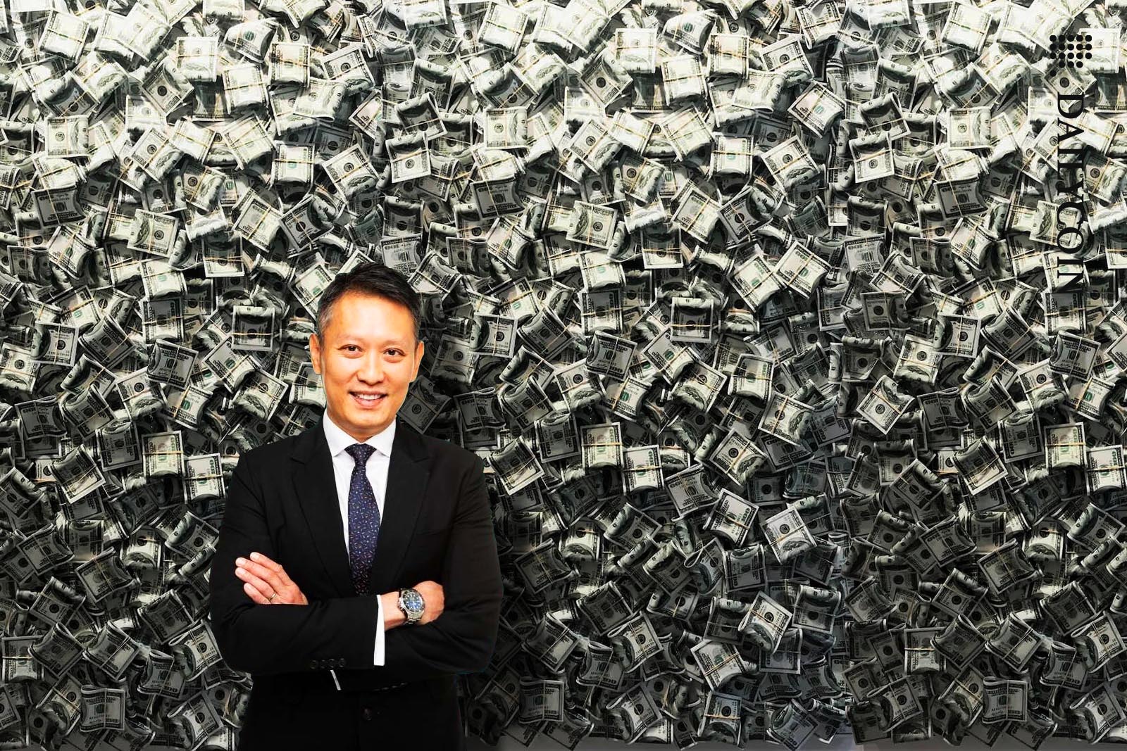 Richard Teng of Binance posing in front of a wall of cash.