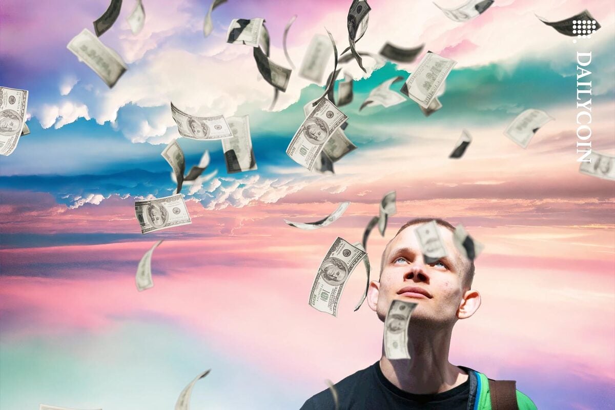 Vitalik Butterin looking up the sky as money raining from it.
